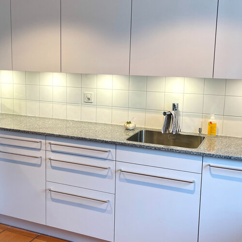 Küchenrückwand mit weissen handgemachten Platten treffen einen moderne Küche mit viel Abstellfläche.